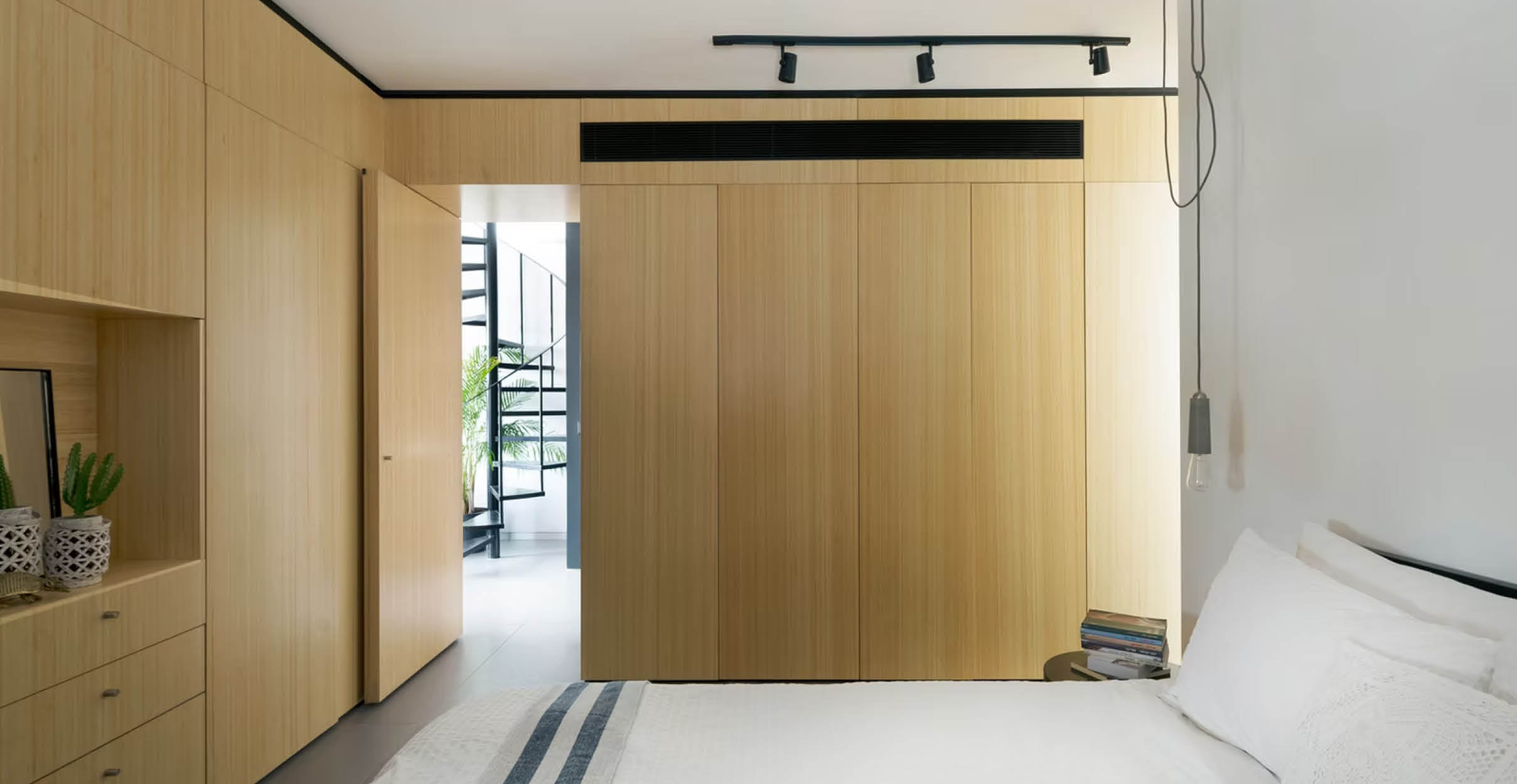 Bedroom with light wooden modern cabinets