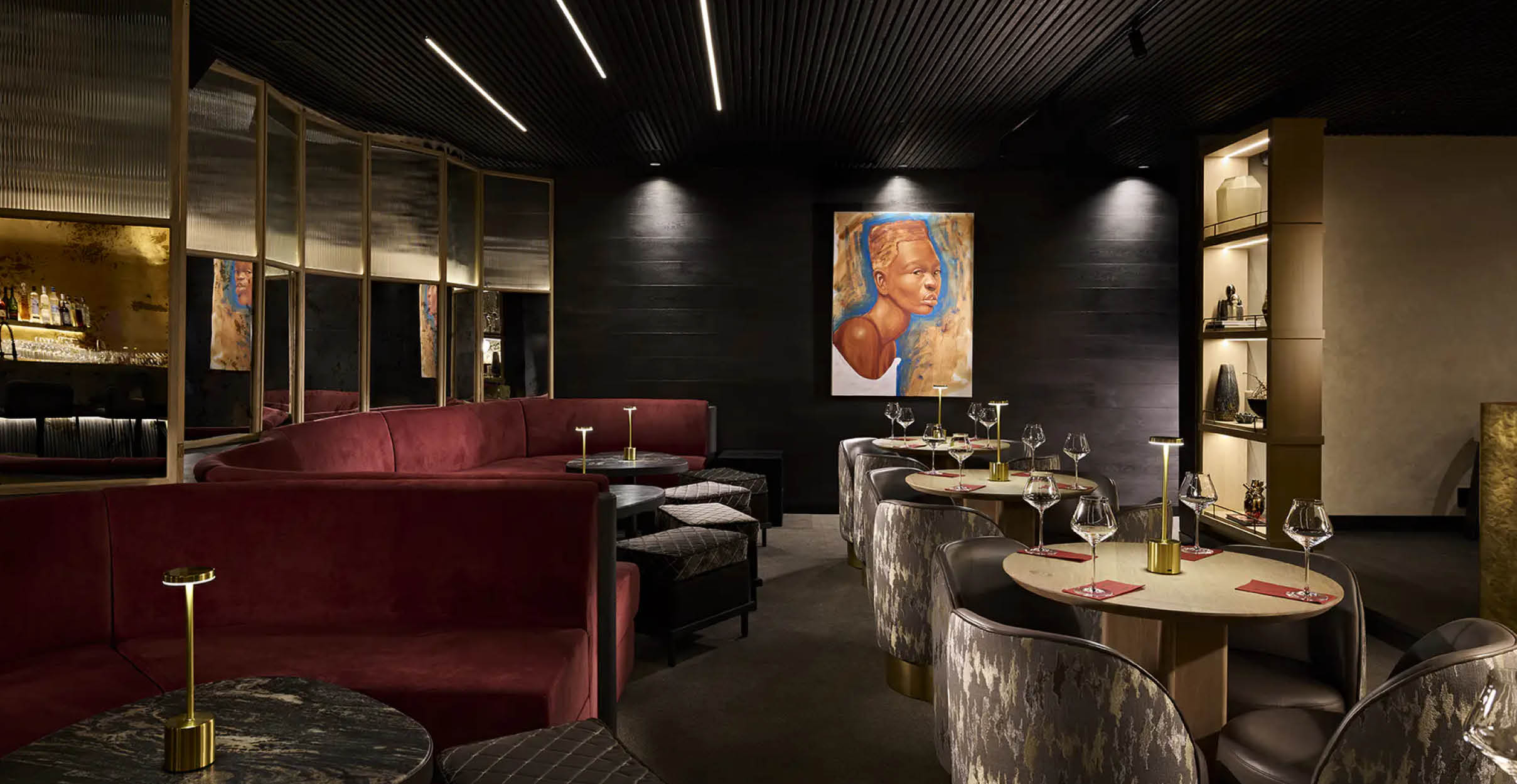Dark commercial restaurant interior with maroon banquet