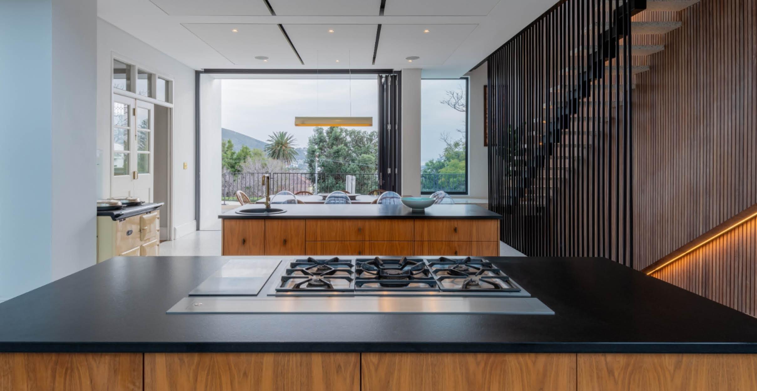 Black countertop with wooden kitchen in modern residential building