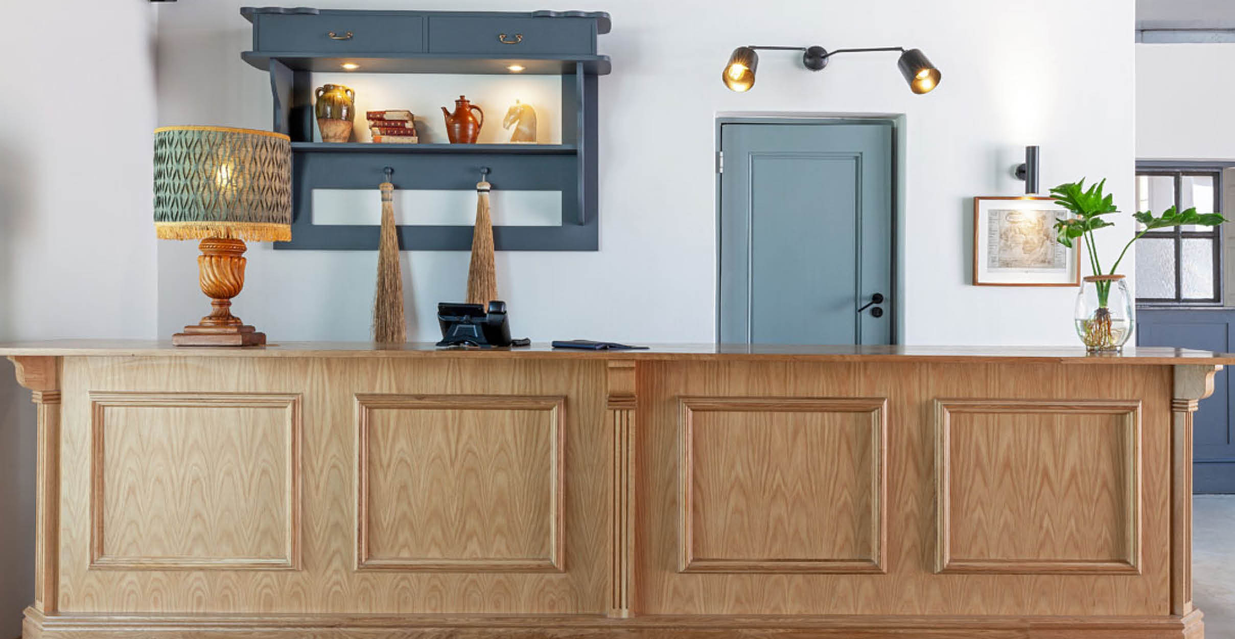 Retail wooden point of sale counter with light blue door behind